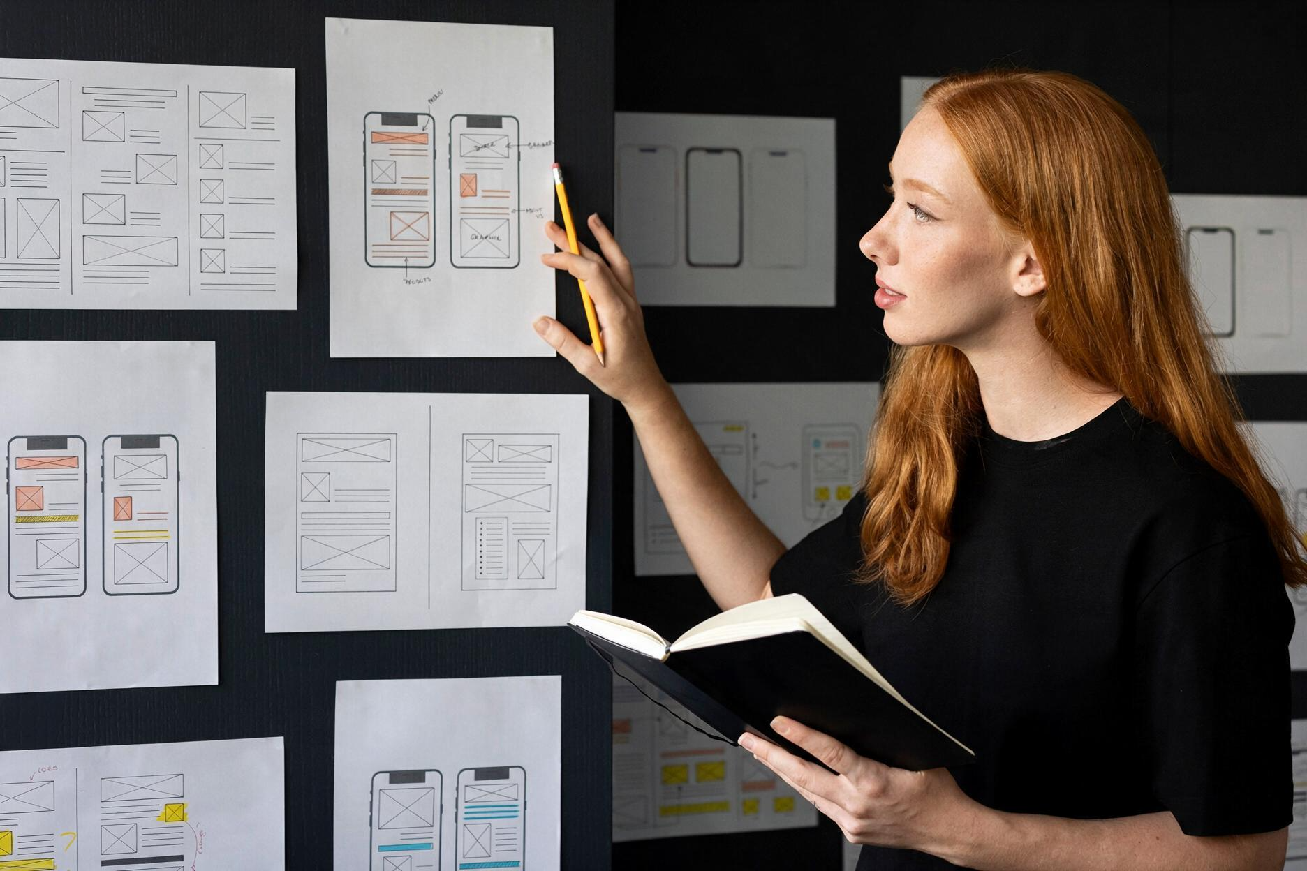 Instructor reviewing website and mobile app wireframes during a design lesson