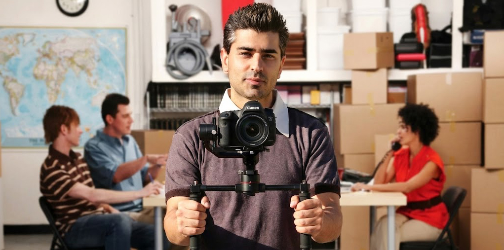 Professional videographer with camera in creative workspace